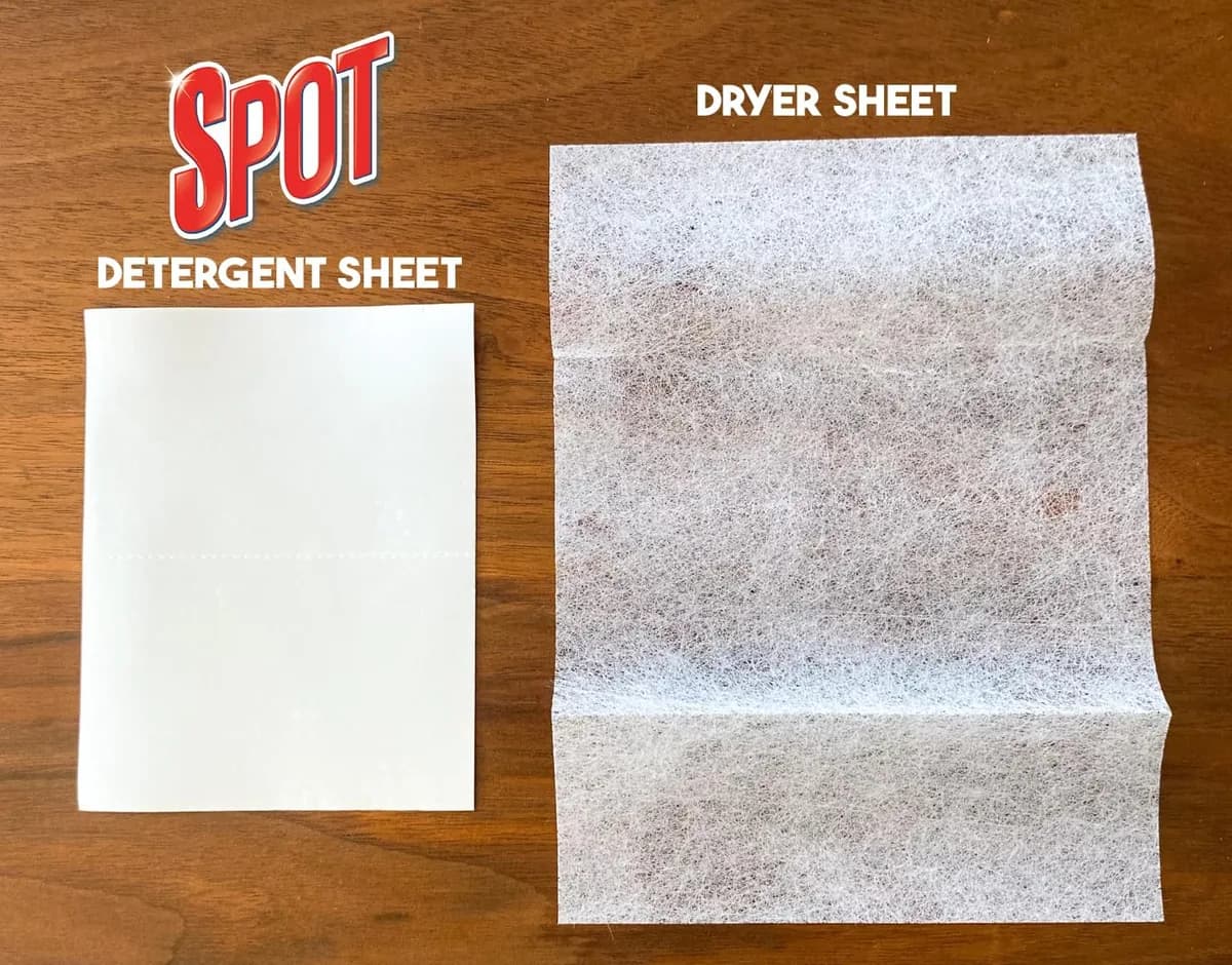 Spot detergent sheet next to a dryer sheet for size comparison